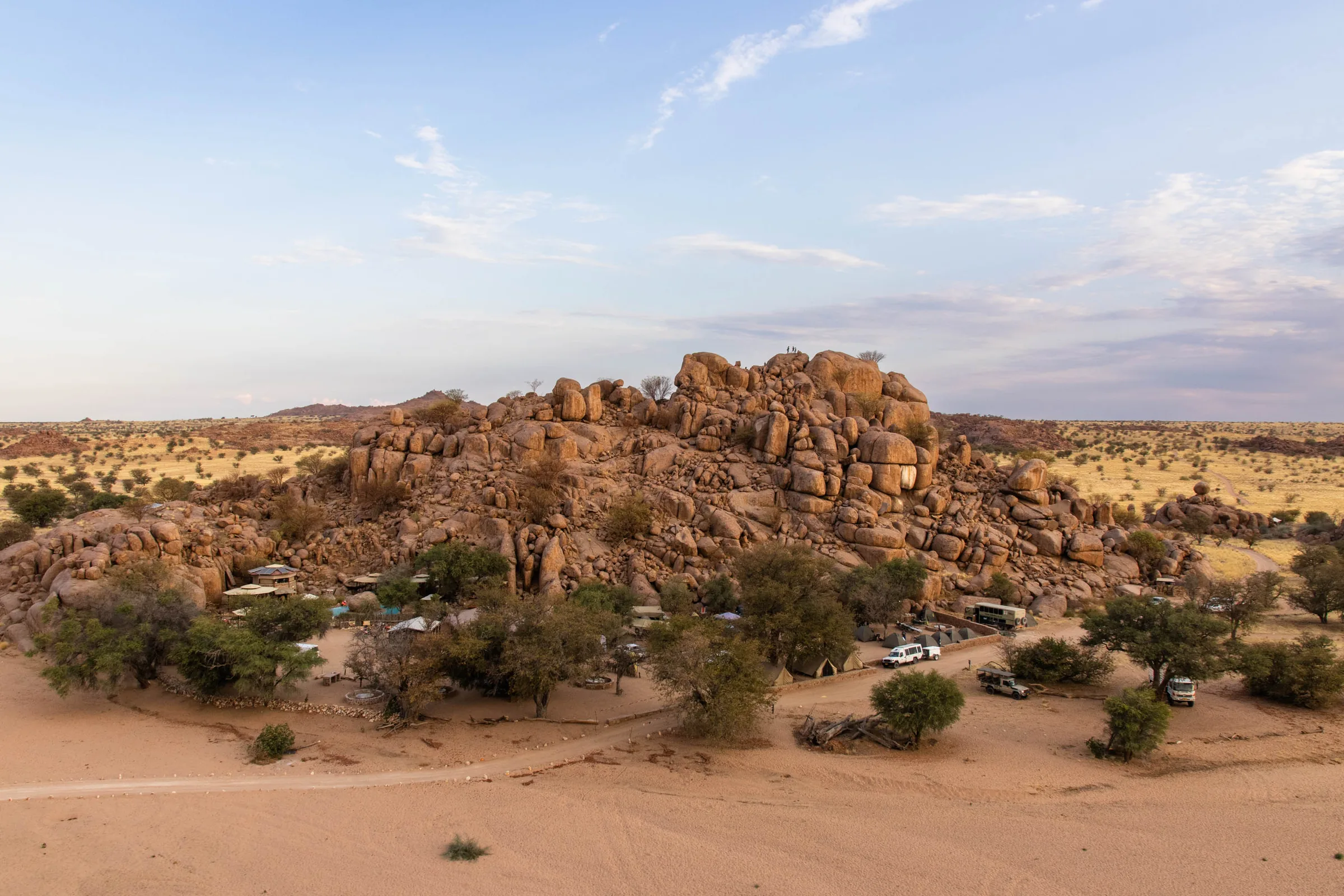 An aerial view of Madisa Camp set beneath granite boulders in Damaraland.