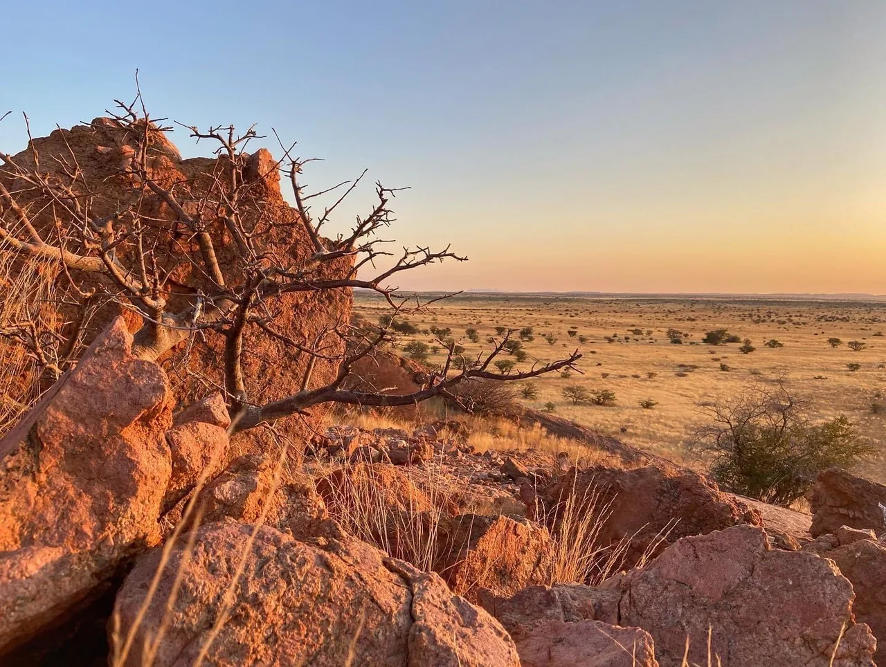 A wide Damaraland view from a rocky sunset koppie.