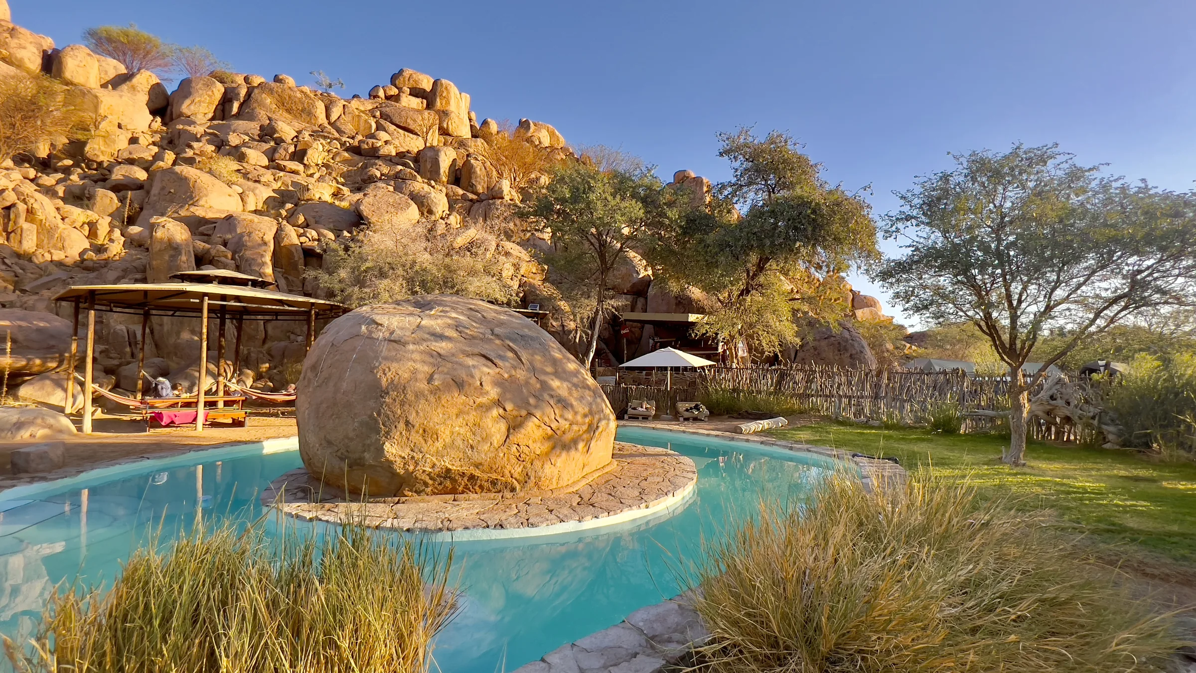 The rock pool and granite boulders at Madisa Camp in Damaraland.