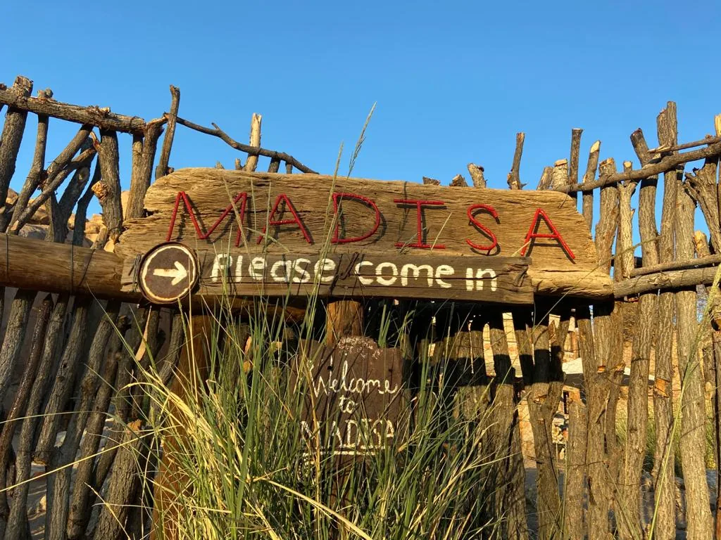 The hand-painted Madisa Camp entrance sign.