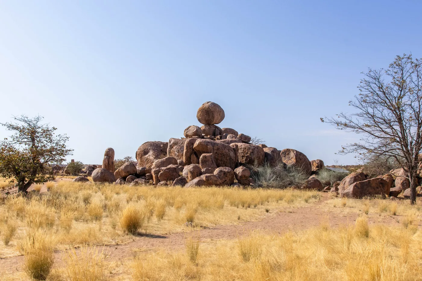 Granite formations and golden grass at Madisa Camp.
